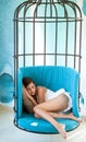 Lost in a deep sleep. daytime sleep of tired girl in cage chair. woman sleep in iron cage. sweet comfort dream, morning