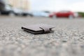 Lost leather wallet lies on road closeup Royalty Free Stock Photo