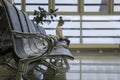 Lost, lonely child. Departure lounge at the airport. Airport terminal, empty waiting chairs. Royalty Free Stock Photo