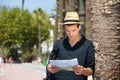 Lost man with map and bag standing outside Royalty Free Stock Photo