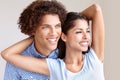 Lost in our love...Studio shot of a gorgeous ethnic couple holding each other and smiling. Royalty Free Stock Photo