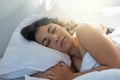 Lost in a peaceful slumber. Shot of an attractive young woman sleeping in bed. Royalty Free Stock Photo