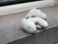 Lost sheep, cuddly toy or stuffed animal laying on the windowsill
