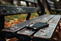 Lost smartphone on park bench, a visual tale of abandonment