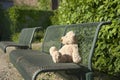 Lost teddy bear on a bench