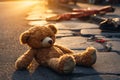 A lost teddy bear sadly lying on the street, seeking its owner
