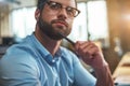 Lost in thougths. Portrait of young bearded man in eyeglasses and formal wear looking away and thinking while working in