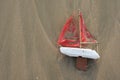 Lost toy boat washed up on beach from above