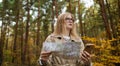 Lost traveler young woman searching direction in with a Topographic Map in the forest. High quality photo Royalty Free Stock Photo