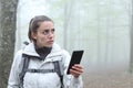 Lost trekker using phone to locate in a forest