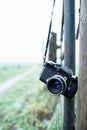 Lost vintage SLR camera hanging on fence post Royalty Free Stock Photo