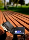 Lost Wallet on Park Bench Waiting to Be Taken or Found Cash and Cards Royalty Free Stock Photo