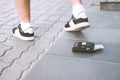 Lost wallet under the feet of a guy on the road Royalty Free Stock Photo