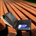 Lost Wallet on Wooden Bench Left by Owner Royalty Free Stock Photo