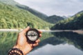 Lost woman on the mountain, orienting herself with a compass. Find a solution Royalty Free Stock Photo