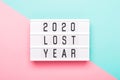 2020 lost year concept. Lightboard with text 2020 lost year on paper geometric background Royalty Free Stock Photo