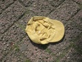 lost yellow cotton cap on a brick street Royalty Free Stock Photo