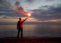 Losted Man on a Beach Holding Emergency Fire