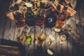 A lot of alcohol, whiskey, tequila, bourbon, brandy, rum on a wooden bar counter, vintage photo