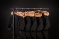 lot of black coats, jacket with fur on hood hanging clothes rack. background.