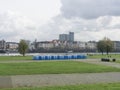 Blue bio toilets on the green embankment of the river