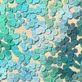 A lot of blue colored vintage clothing plastic buttons randomly scattered on the light woody background - top view