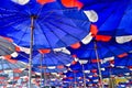 A Lot Of Blue And Red Umbrellas On A Beach