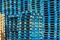 Lot of blue wooden empty pallet stacked at container port waiting for collection