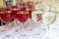 Lot of blurred glasses with red and white wine on the reception party table Royalty Free Stock Photo