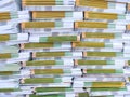 Lot of books stacked in layers in huge endless wall of knowledge. Industrial printing house. Book spines folded into Royalty Free Stock Photo