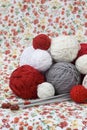 A lot of bright balls of knitting on the background of a red flo Royalty Free Stock Photo