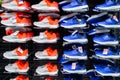 Moscow, Russia, July 2020: Lot of bright sneakers orange and blue color for boys and girls on the shelves in the store