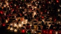 Lot of burning candles at night in cemetery.Glass inextinguishable lamps for cemetery.Day of remembrance and mourning for the dead Royalty Free Stock Photo