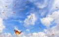 Lot butterflies flutter in the bright blue sky on a beautiful sunny day.