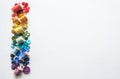 A lot of buttons and reels with colorful threads, laid out on a white background in the colors of the rainbow. Copy space