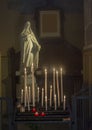 A Lot Of Candles And Statue Of The Virgin Mary In A Church