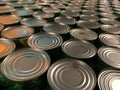 A lot of canned goods at the grocery store. Background texture: round cans, preservation