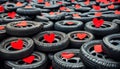 A lot of car tires with red paper hearts.