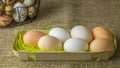 A lot of chicken eggs and quail eggs lies of a metal structure in the shape of a heart and an ear lying on the wooden table Royalty Free Stock Photo