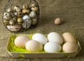 A lot of chicken eggs and quail eggs lies of a metal structure in the shape of a heart and an ear lying on the wooden table Royalty Free Stock Photo