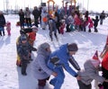 A lot of children playing in the street at the holiday Christmas traditional winter fun in Siberia January