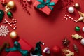 A lot of Christmas ornament such as gift boxes, candy cane, reindeer and baubles are arranged on the red background Royalty Free Stock Photo