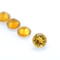 Lot of citrine quartz stones with diamond cut. Nice yellow-orange gemstone on isolated background Royalty Free Stock Photo