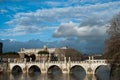 Lot of Clouds under the Tiber river and Bridge Ponte Sant Angelo near of Castel Sant Angelo, Roma, Italy, February 2018. Bridge Royalty Free Stock Photo