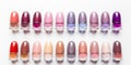 A lot of colorful bottles with nail polish lie on white background top view close up.Row of nail polishes for manicure Royalty Free Stock Photo