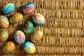 A lot of colorful Easter eggs is on the background of braided willow branches