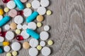 Lot of colorful medication and pills from above on grey wooden background. Copy space. Top view, frame. Painkillers, tablets, gene Royalty Free Stock Photo