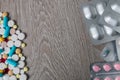 Lot of colorful medication and pills from above on grey wooden background. Copy space. Top view, frame. Painkillers, tablets, gene Royalty Free Stock Photo