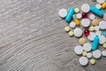 lot of colorful medication and pills from above on grey wooden background. Copy space. Top view, frame. Painkillers, tablets, gene Royalty Free Stock Photo