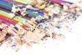 Lot of colorful pencils frame with sawdust and shavings on white Royalty Free Stock Photo